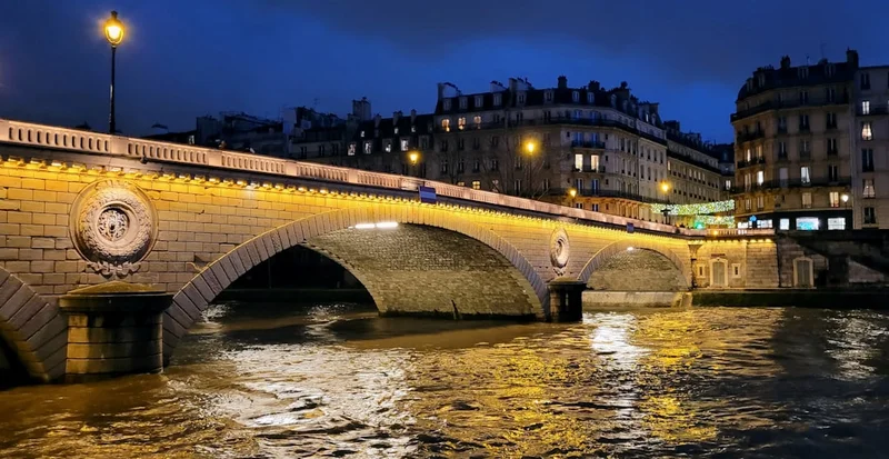 Most preko rijeke nocu sa svjetlima grada